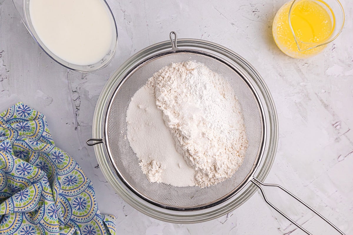 Sifting together dry ingredients in a mixing bowl