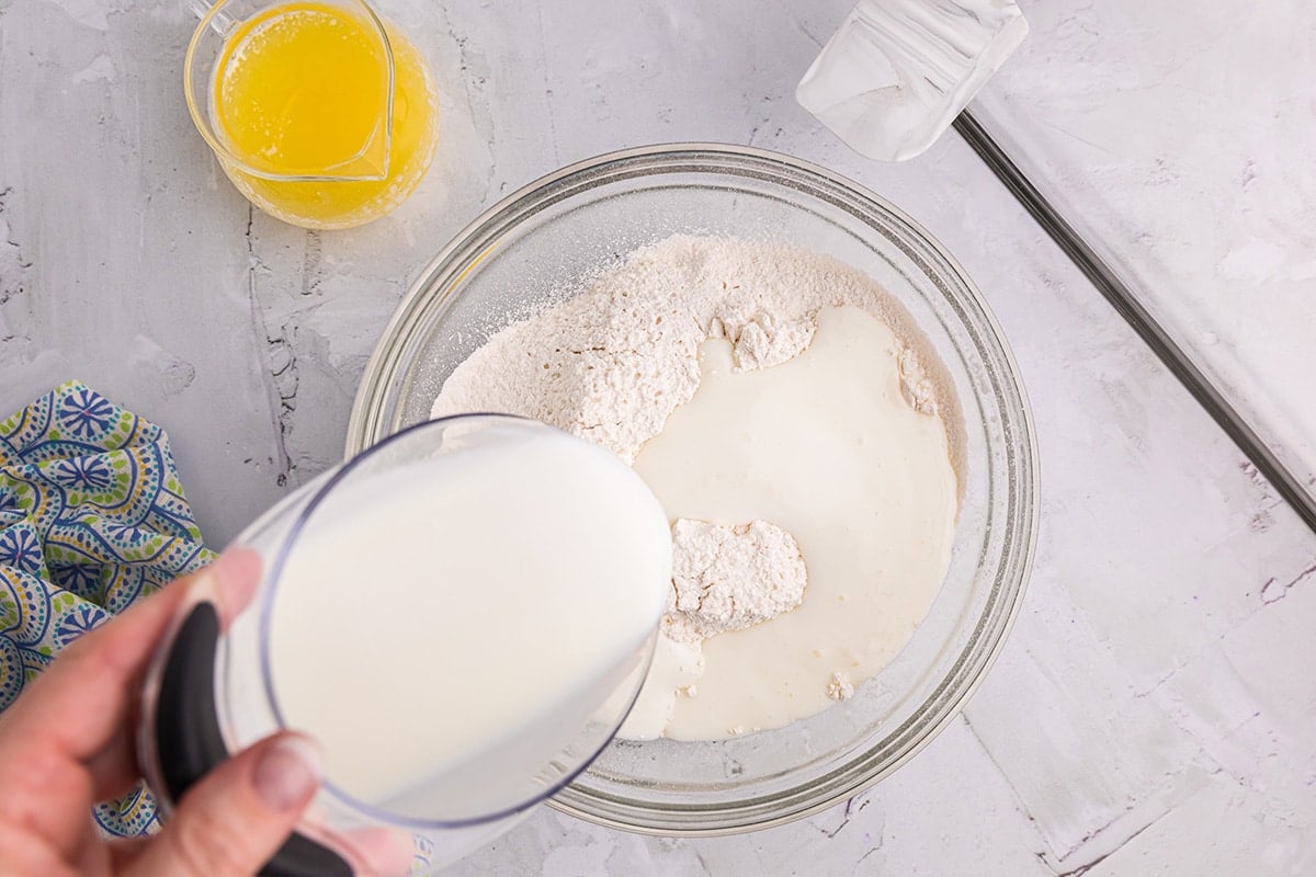 pouring buttermilk into dry ingredients