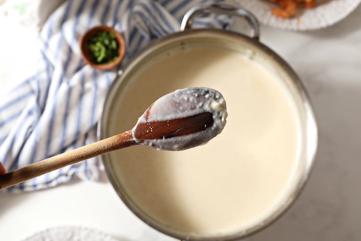 alfredo coating a wooden spoon