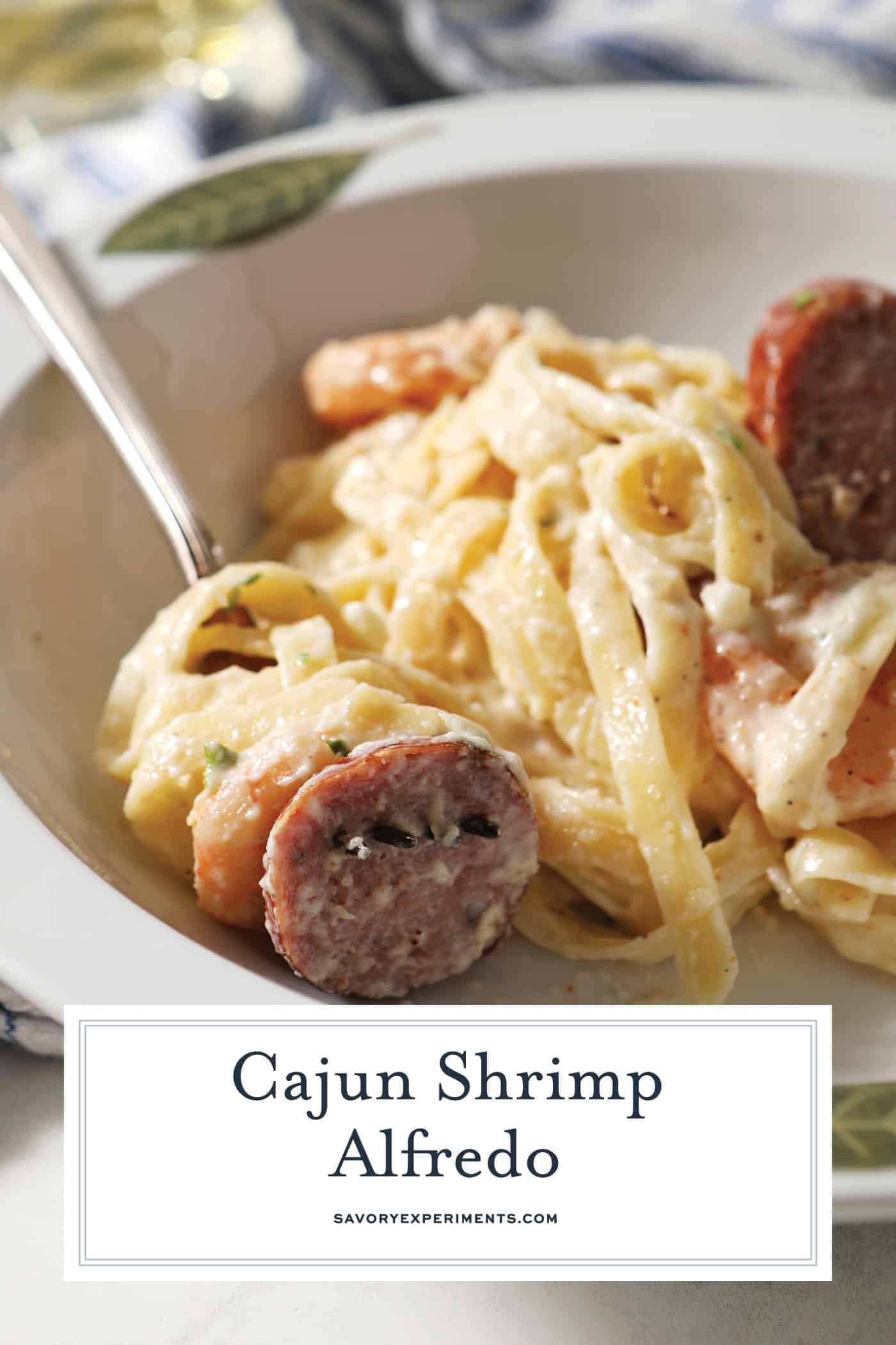 bowl of cajun shrimp alfredo with text overlay for pinterest
