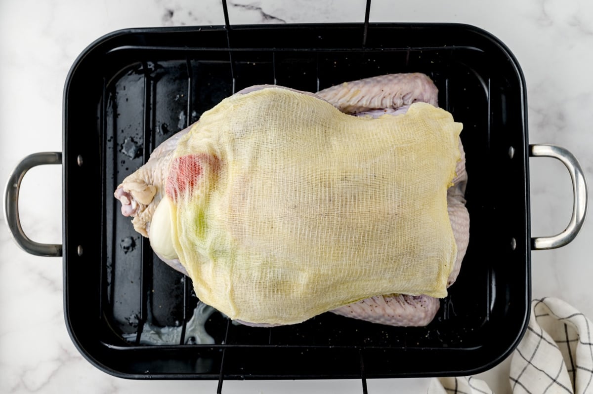 turkey covered in buttered cheesecloth