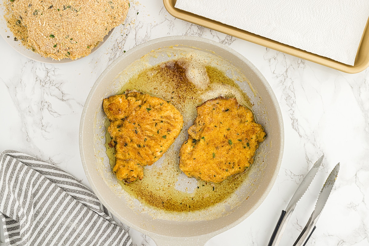 chicken frying in a pan