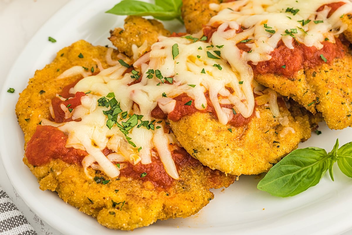 3 pieces of chicken parmesan on a plate
