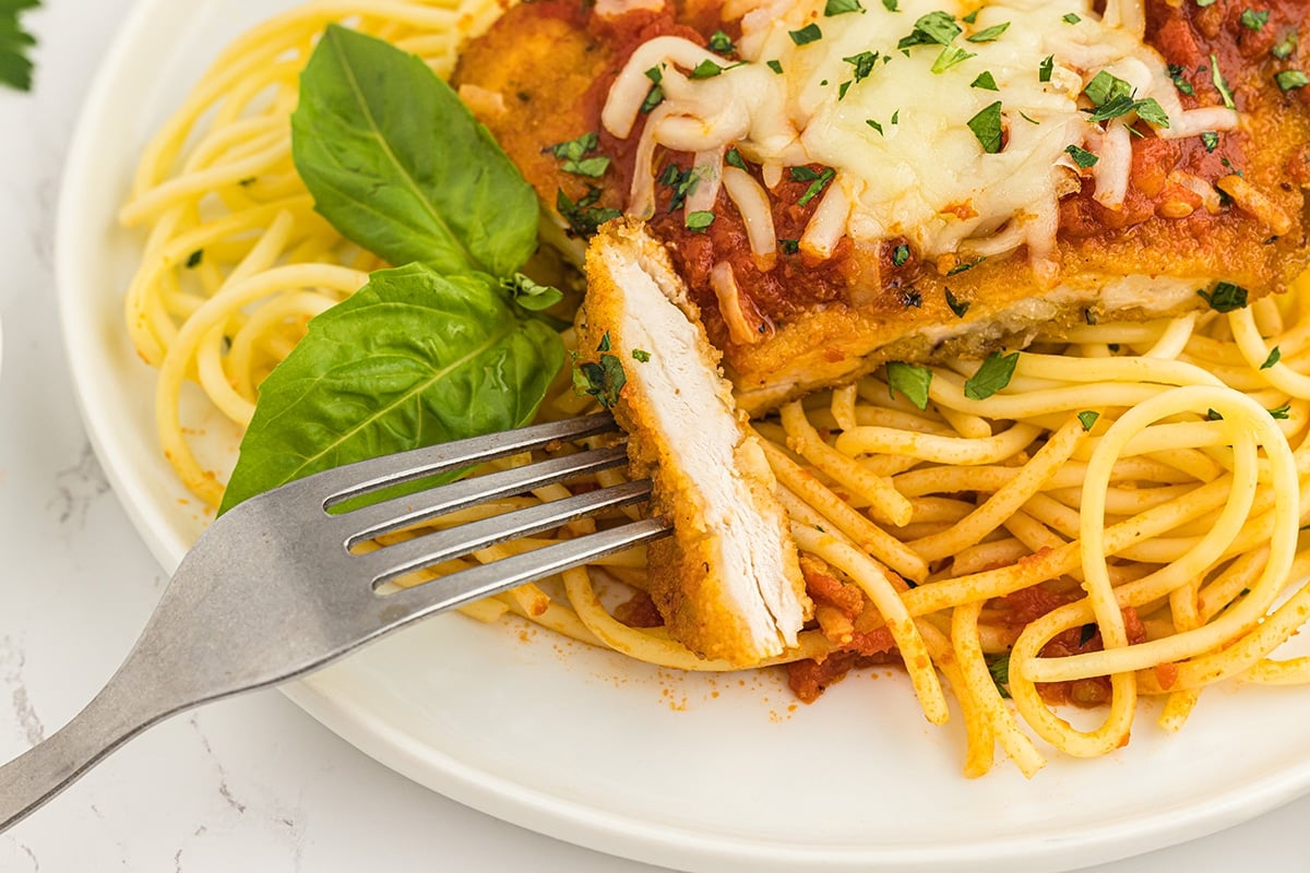 bite of parmesan chicken on fork