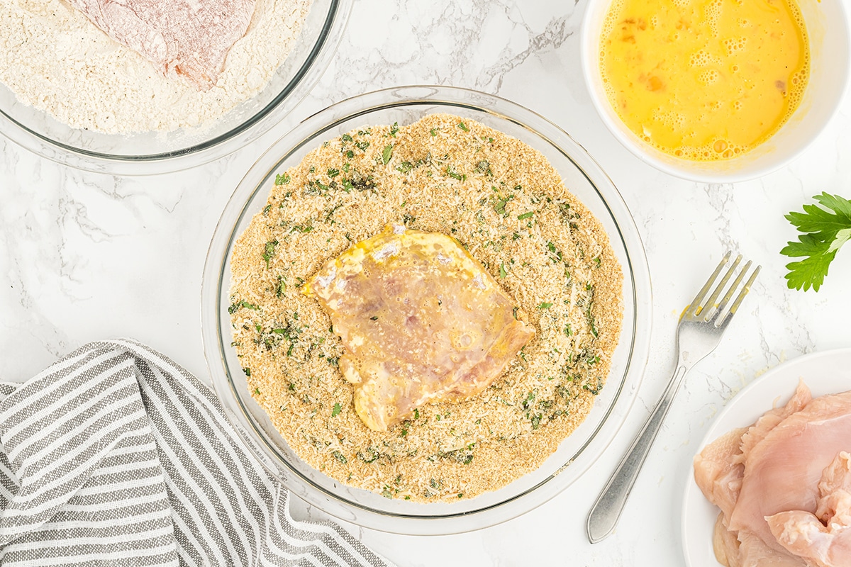 raw chicken in bowl of breading