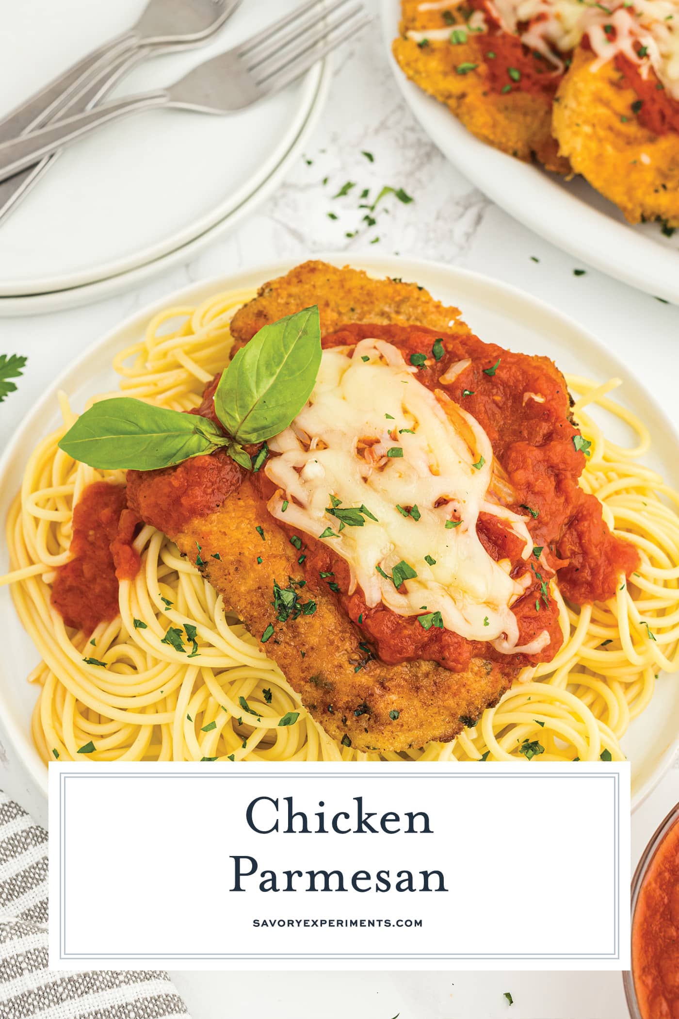 angled shot of chicken parmesan with text overlay for pinterest