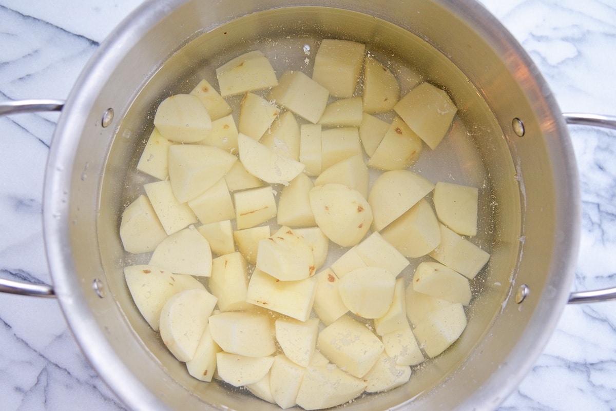 cut potatoes in a pot with water