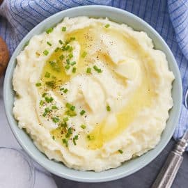 overhead bowl of mashed potatoes with butter and chives