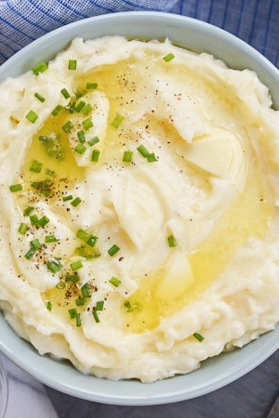 overhead bowl of mashed potatoes with butter and chives