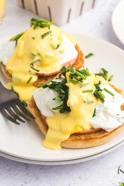 angled shot of eggs benedict on plate