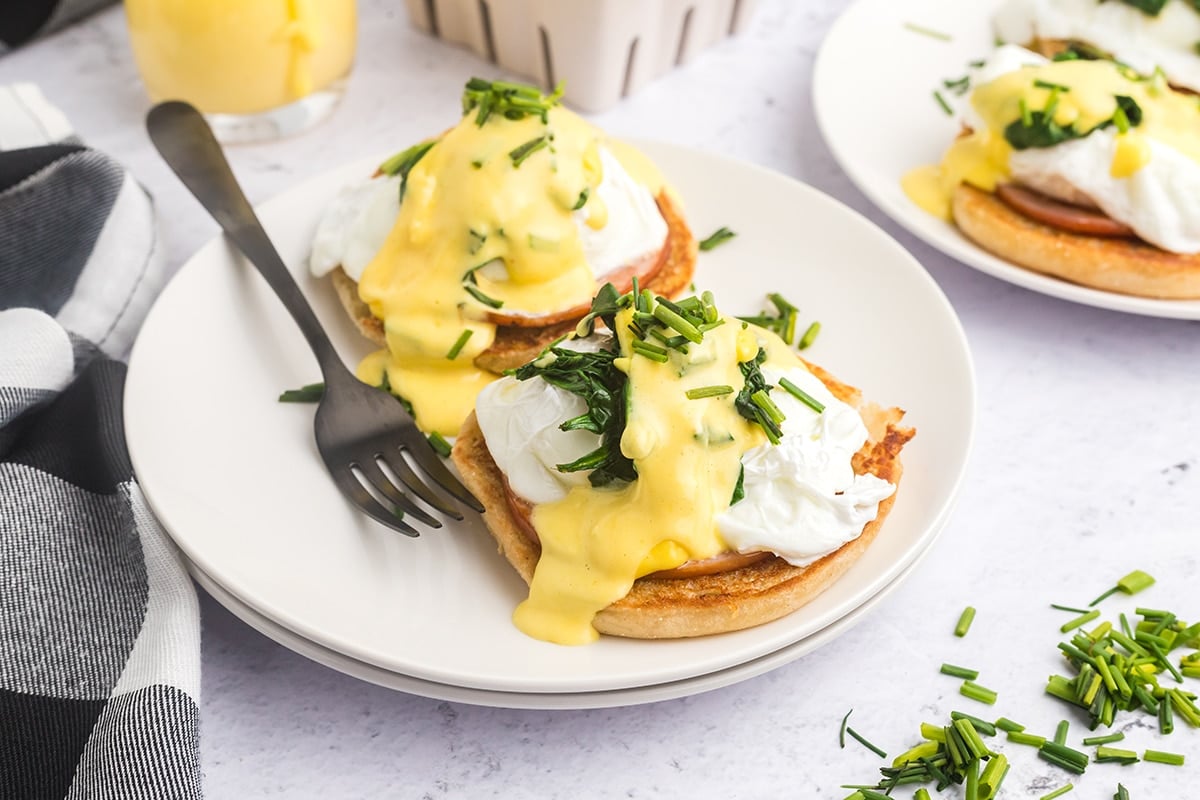 angled shot of eggs benedict on plate