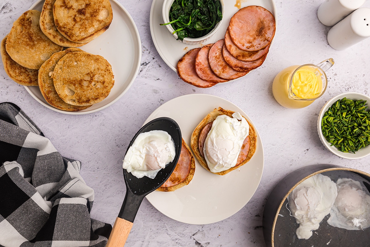 poached egg spooned onto muffins