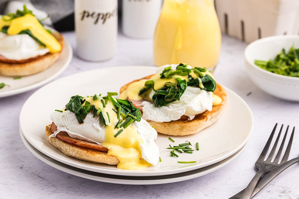 eggs benedict topped with spinach