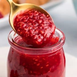 close up of spoon with raspberry coulis