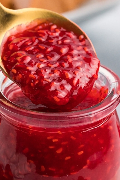 close up of spoon with raspberry coulis