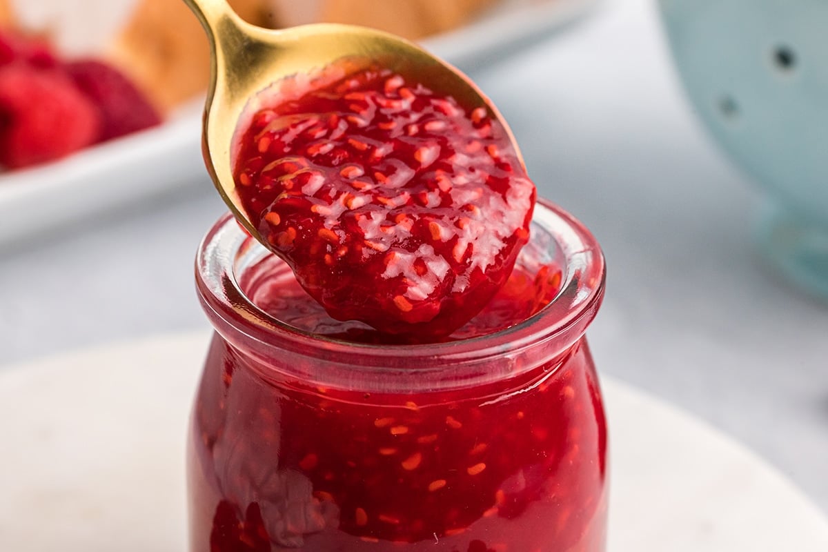 close up of spoon with raspberry coulis