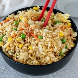 chop sticks in bowl of fried rice