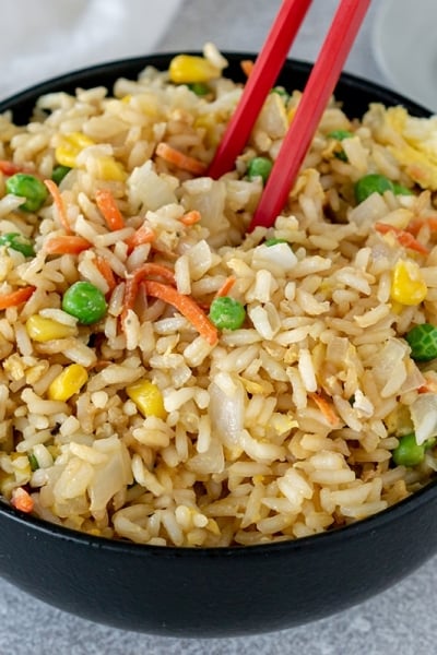 chop sticks in bowl of fried rice