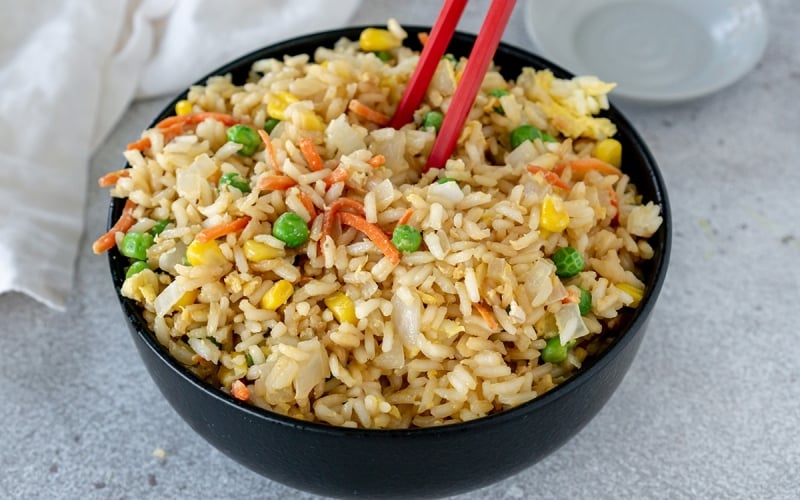 chop sticks in bowl of fried rice
