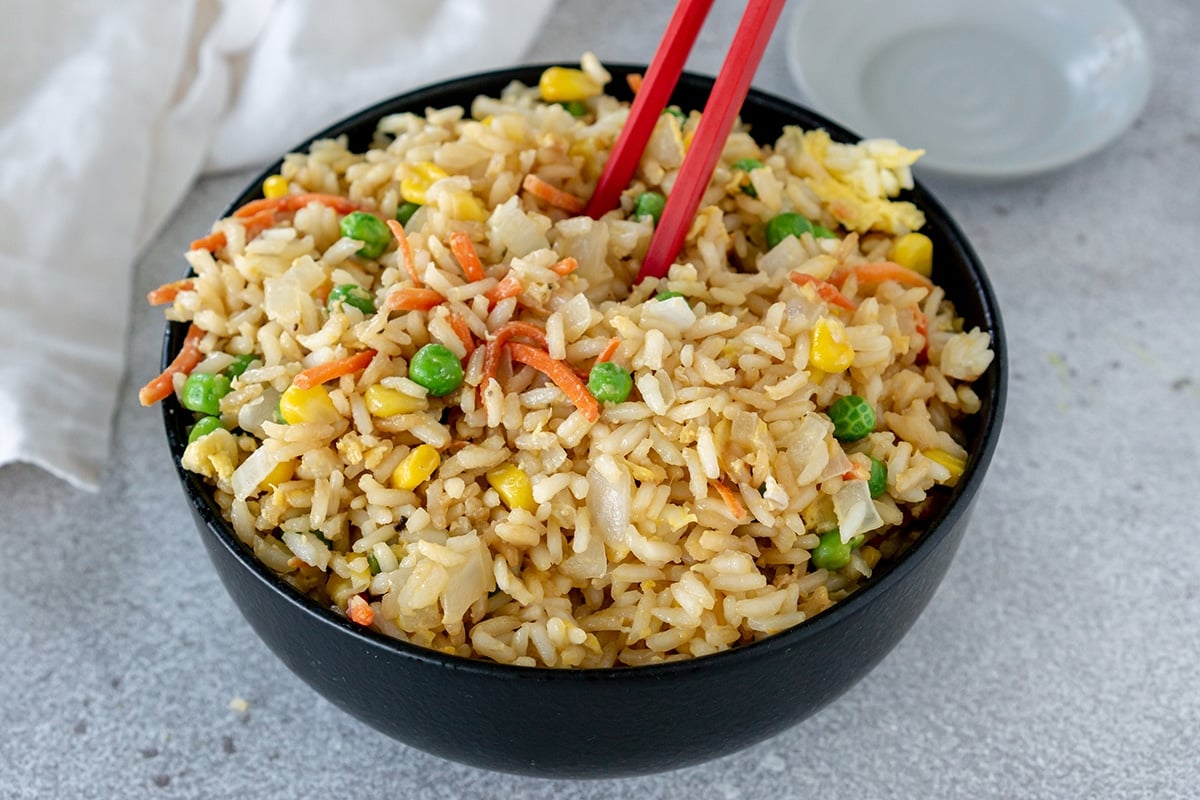 chop sticks in bowl of fried rice