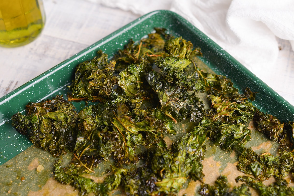 close up of crispy kale chips on a baking sheet