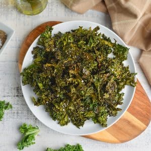 overhead of kale chips in a white plate