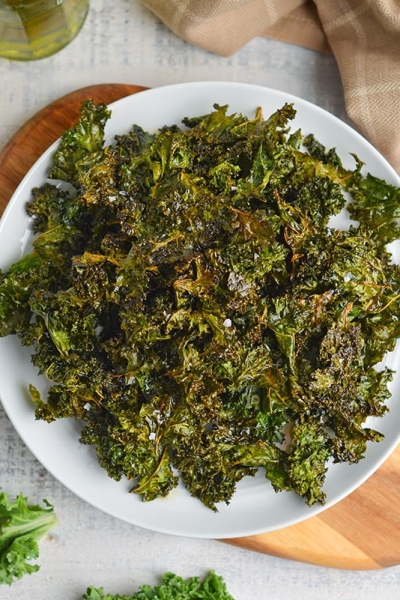 overhead of kale chips in a white plate