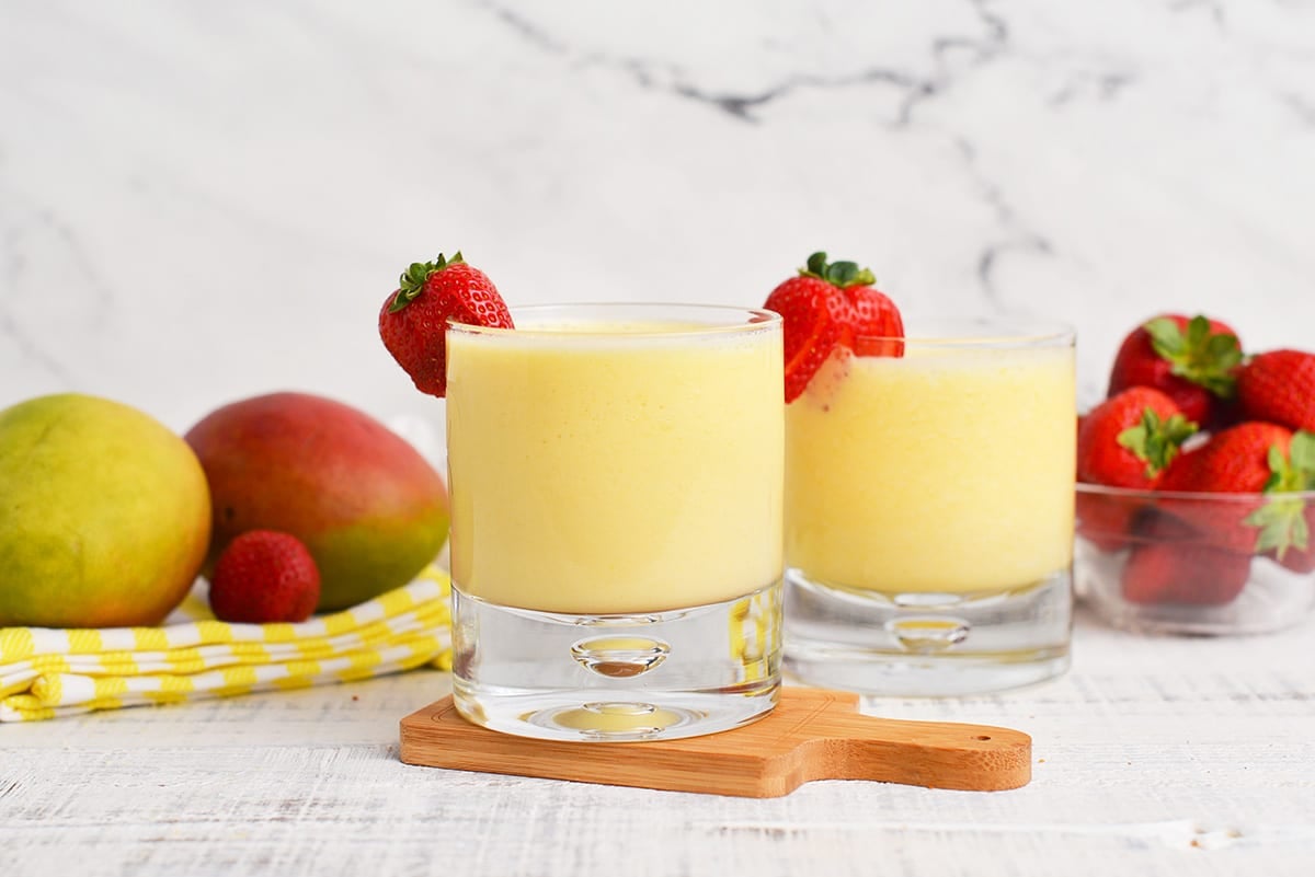 two peach mango smoothies in short glasses