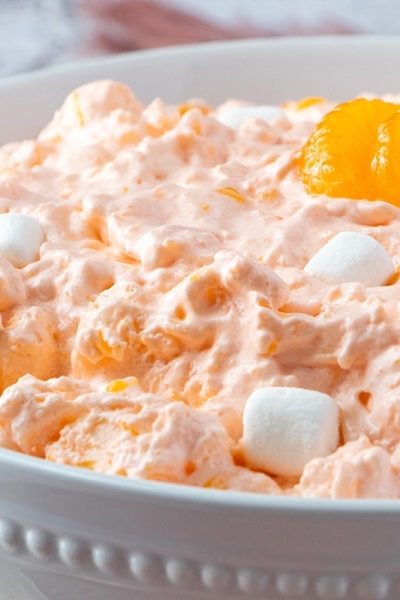 rim view of mandarin orange salad in a white bowl