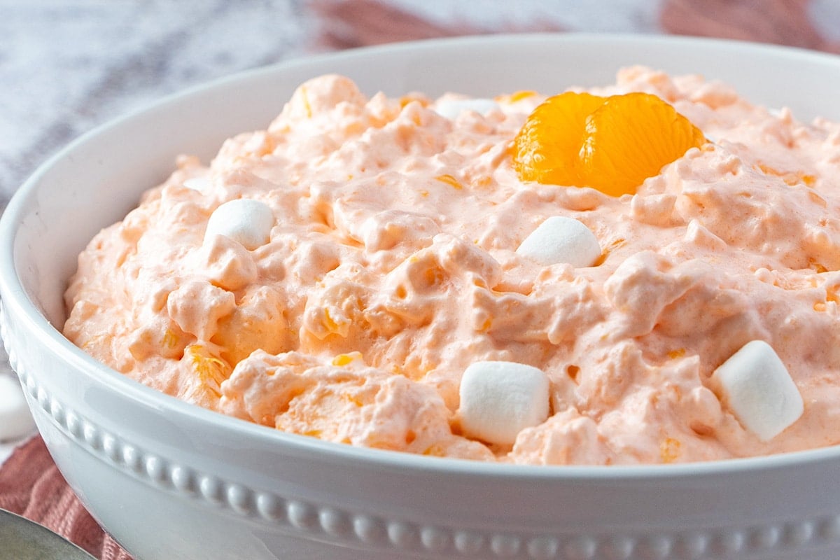 rim view of mandarin orange salad in a white bowl