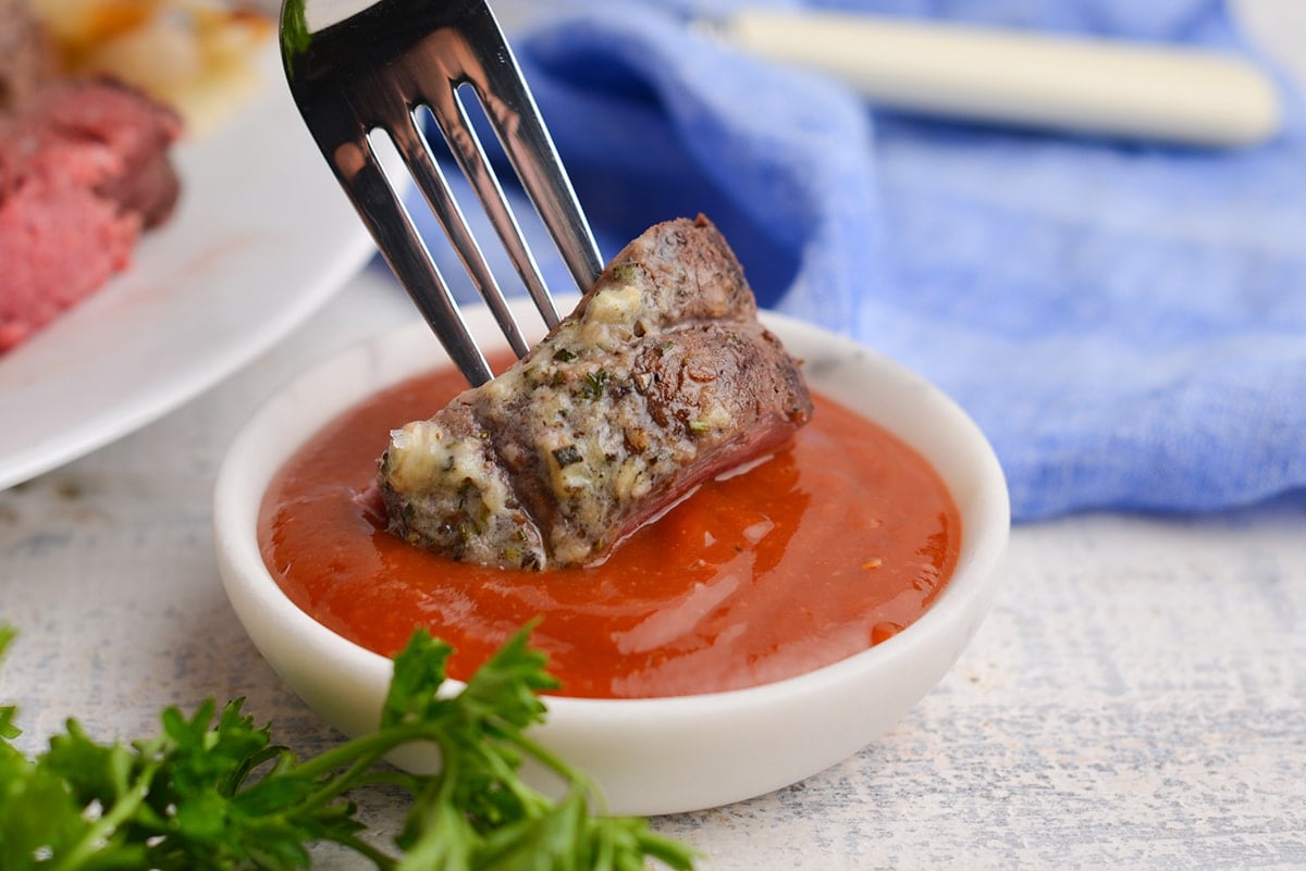 roast beef tenderloin bite dipped in sauce