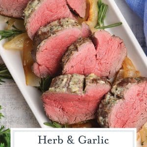 sliced herb and garlic beef tenderloin with text overlay for pinterest