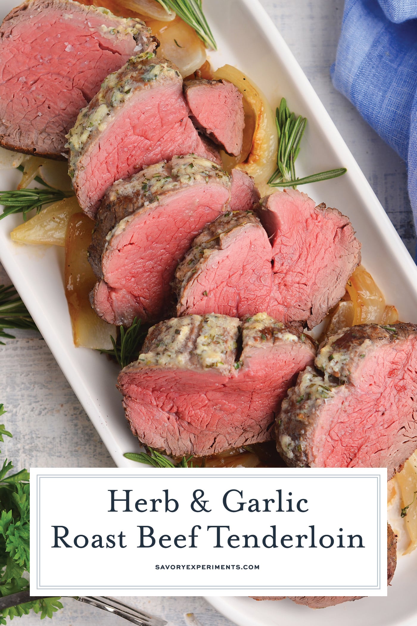 sliced herb and garlic beef tenderloin with text overlay for pinterest