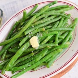 close up melting butter over green beans