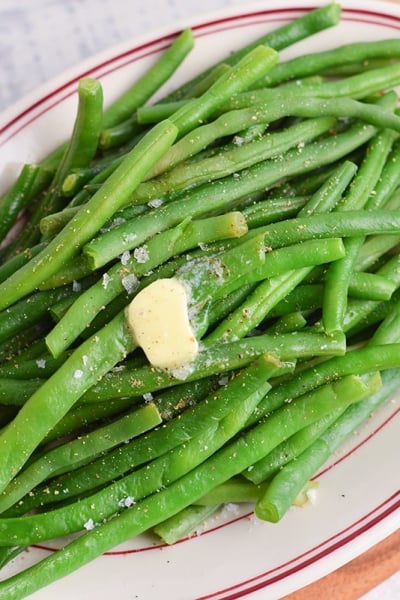 close up melting butter over green beans