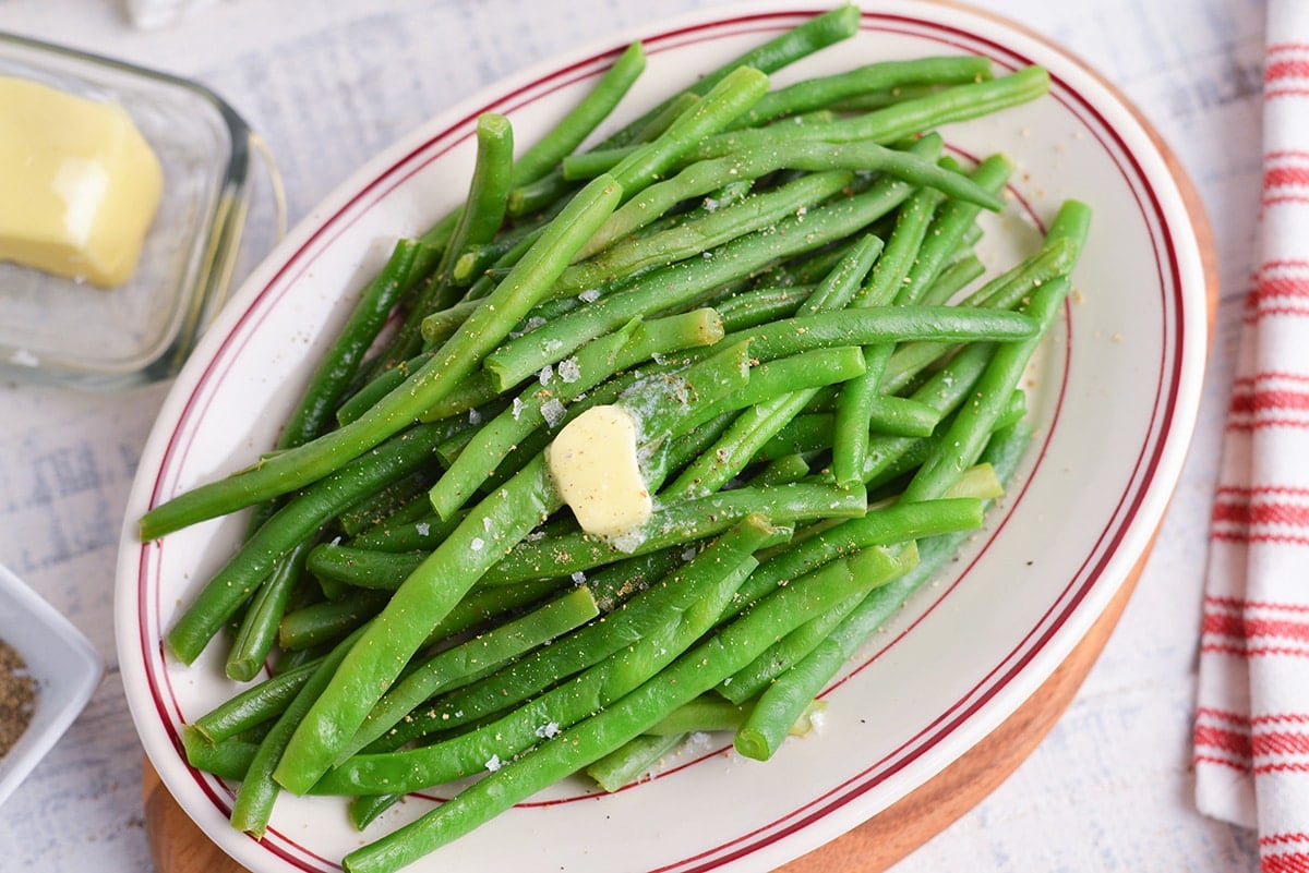 close up melting butter over green beans