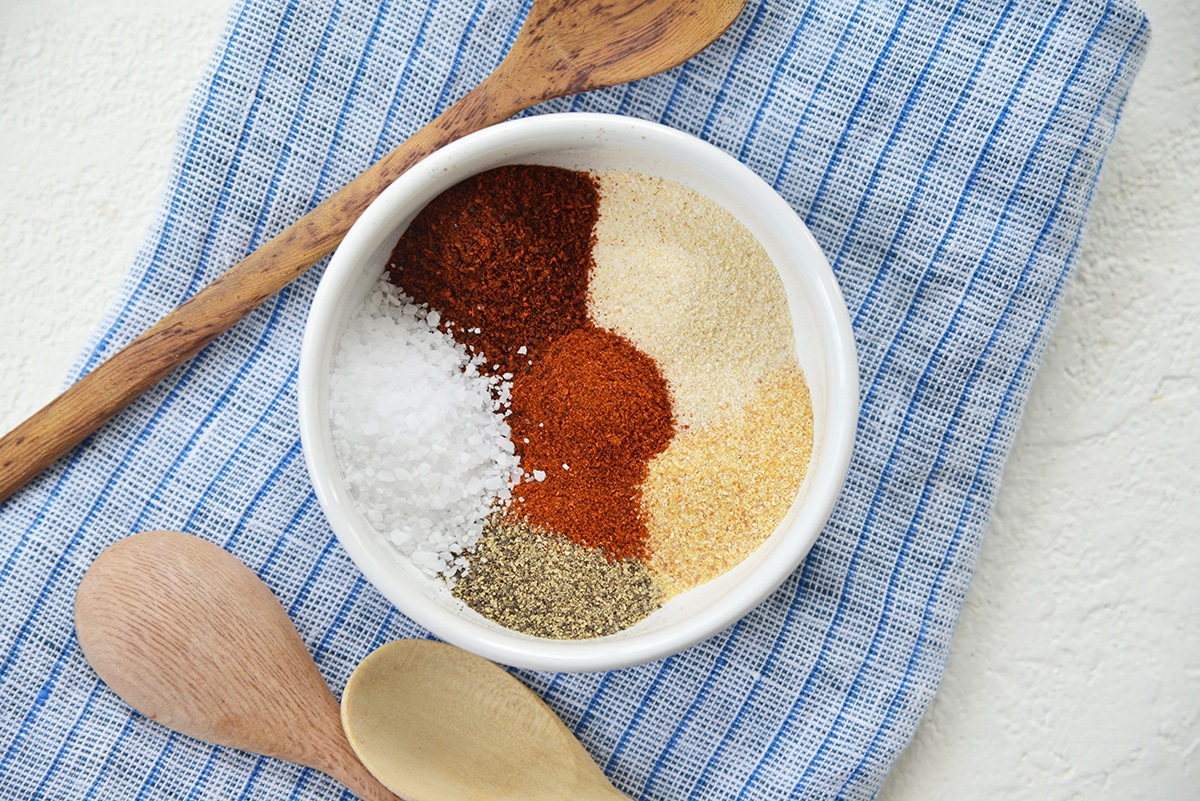 overhead bowl of spices on a blue linen