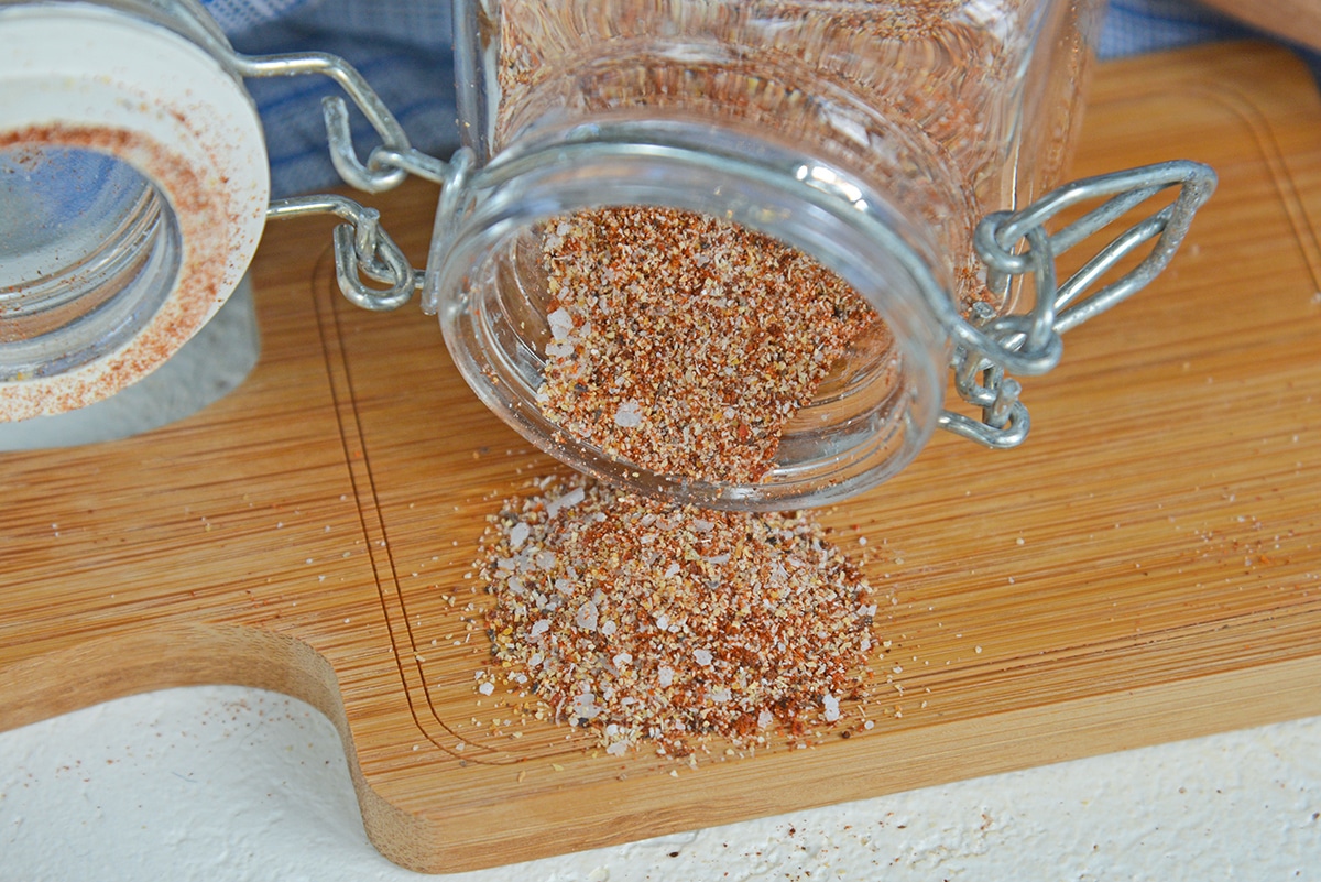 spices spilling out on a wood cutting board
