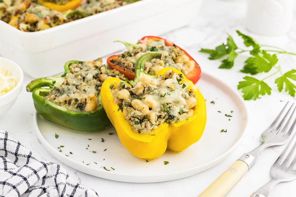 three peppers on a white serving plate