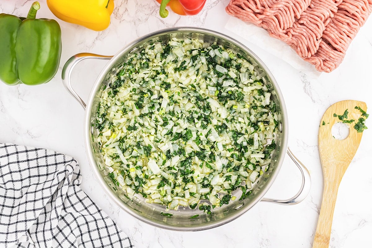 onion, garlic and parsley in a frying pan