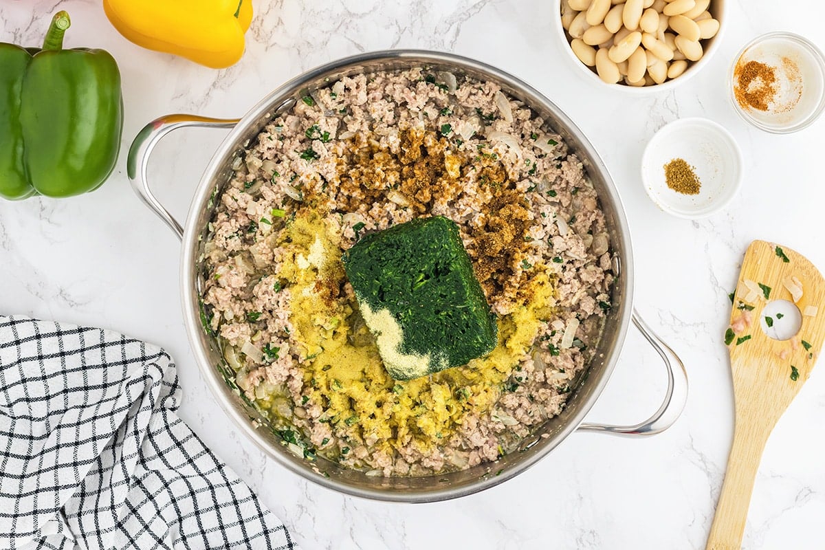 spices and frozen spinach in ground turkey filling