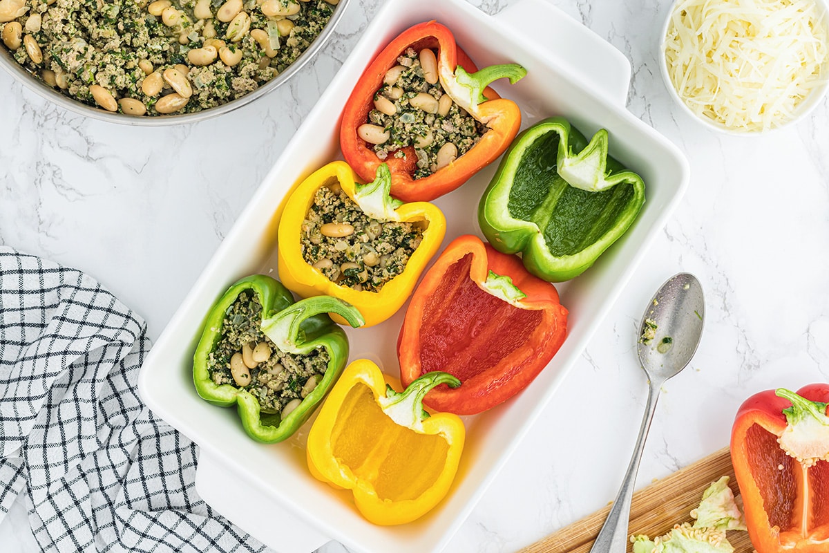 half filled peppers in a casserole dish