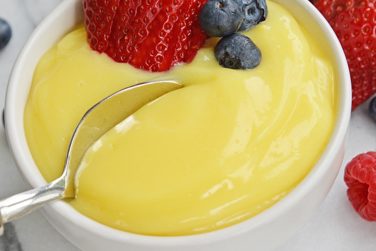 spoon scooping into creamy custard