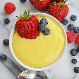 overhead ramekin of vanilla custard with fresh berries