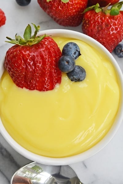 overhead ramekin of vanilla custard with fresh berries