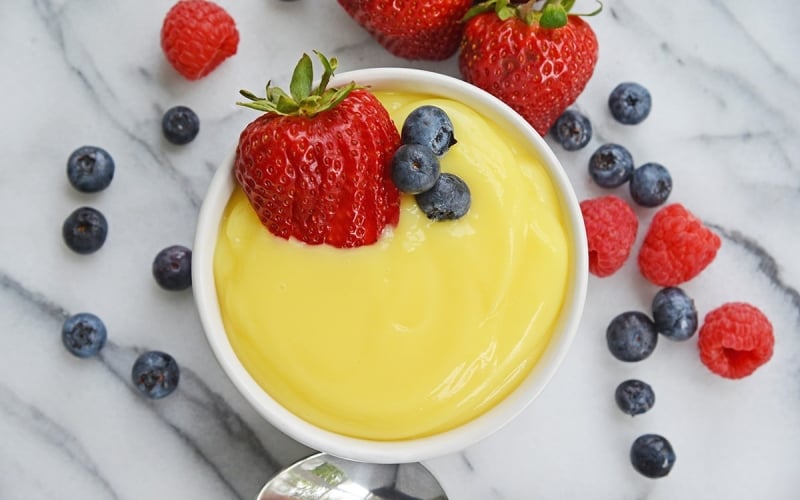 overhead ramekin of vanilla custard with fresh berries