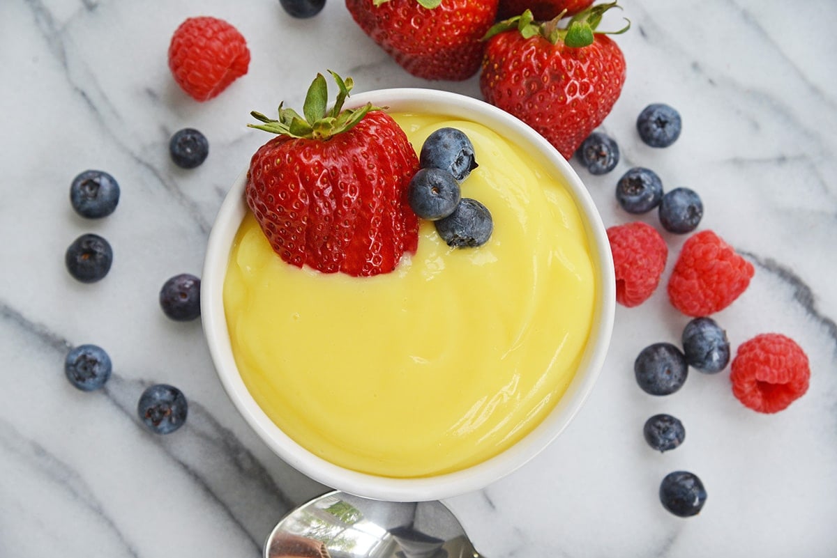 overhead ramekin of vanilla custard with fresh berries