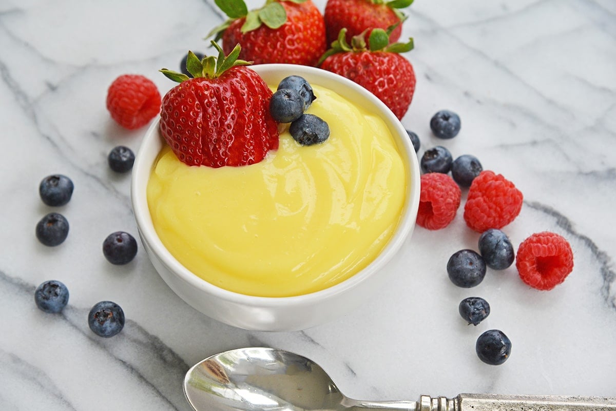 angle view of custard ramekin with fresh berries