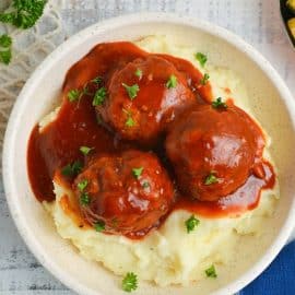 BBQ meatballs over a pile of mashed potatoes