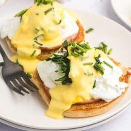 angled shot of eggs benedict on plate
